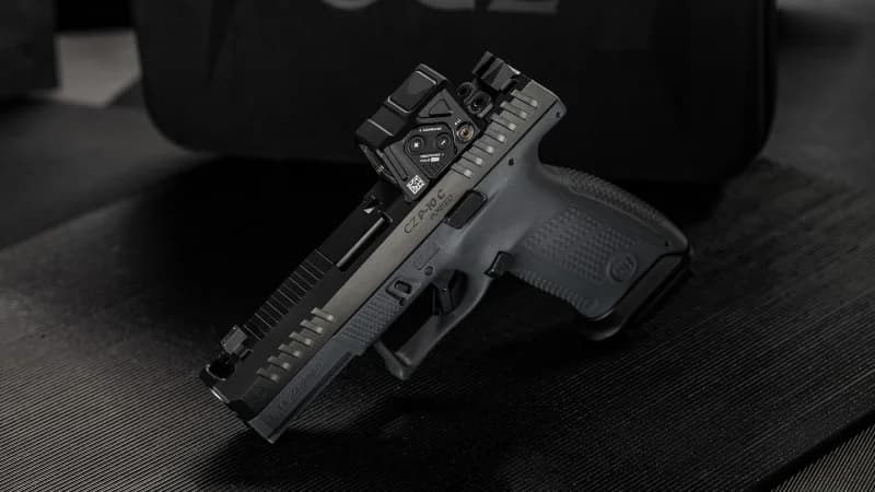 CZ P-10 C Ported COA leaning on CZ branded case with Aimpoint COA and co-witness sights visible