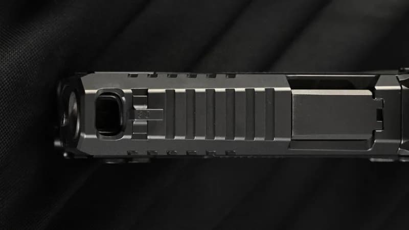 CZ P-10 C Ported slide top-down view showing barrel port, muzzle crown, and extended cocking serrations