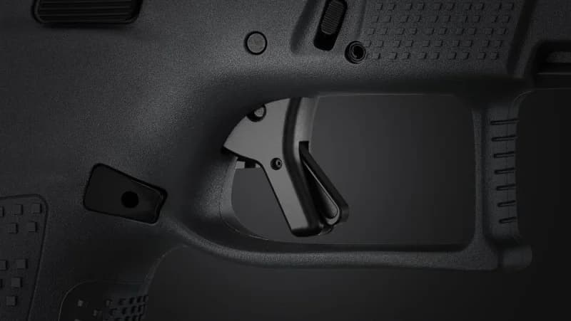 CZ P-10 C Ported COA trigger close-up showing duralumin trigger blade and magazine release