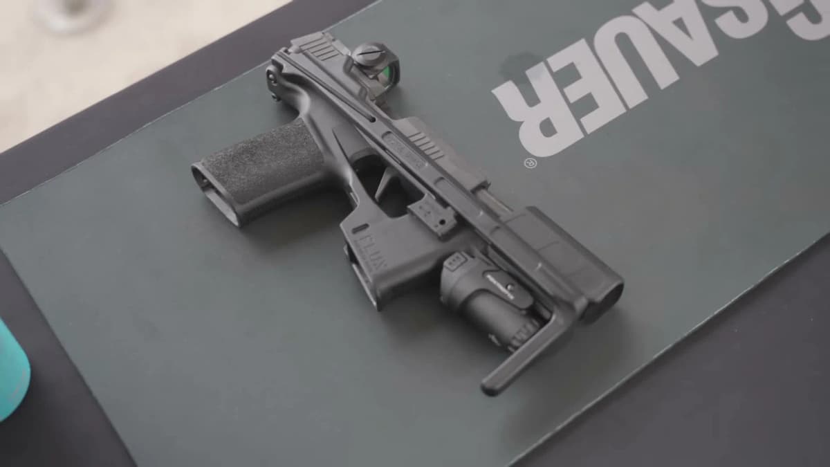 Flux Raider 365 on SIG Sauer display showing black polymer chassis with optic and light