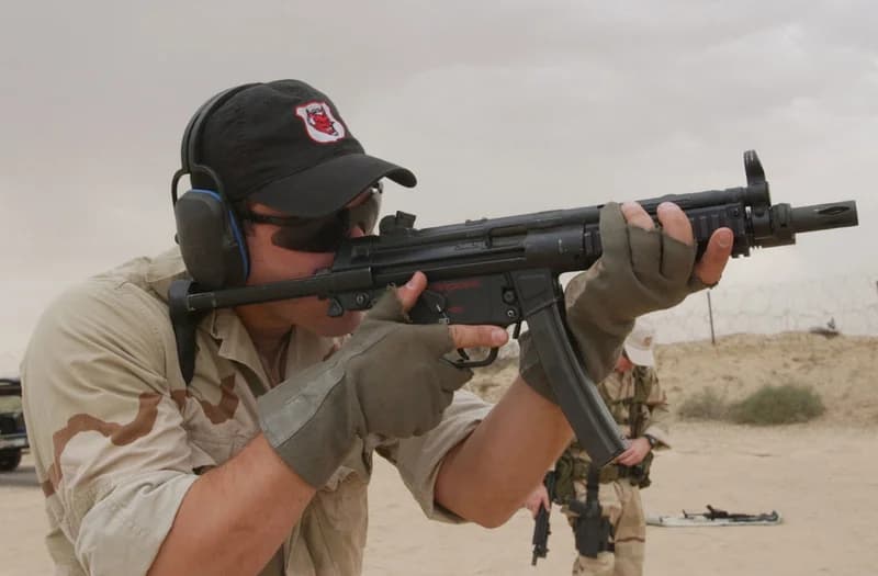 Soldier aiming an HK MP7 personal defense weapon, demonstrating the compact form factor that the civilian SP7 replicates