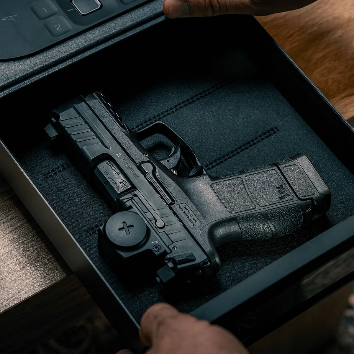 HK VP9CC stored in a bedside safe, showing the compact form factor for home defense carry