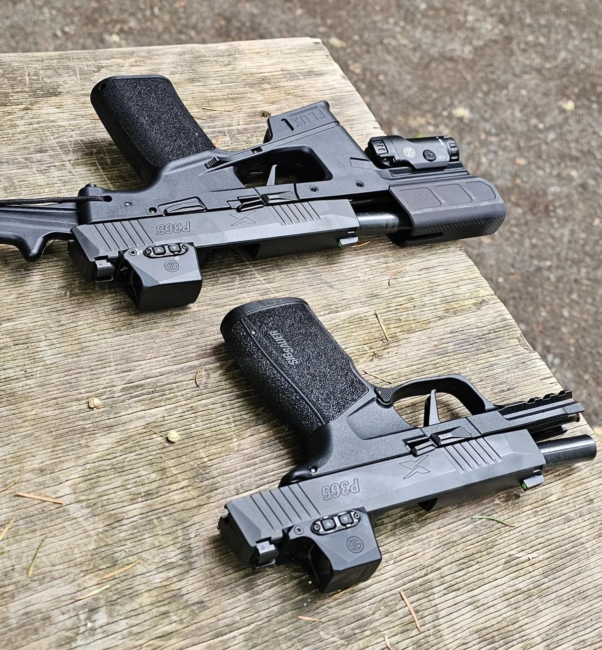 SIG P365-FLUX TACKIT and SIG P365 X-Macro laid grip-to-muzzle on a wood bench for size comparison