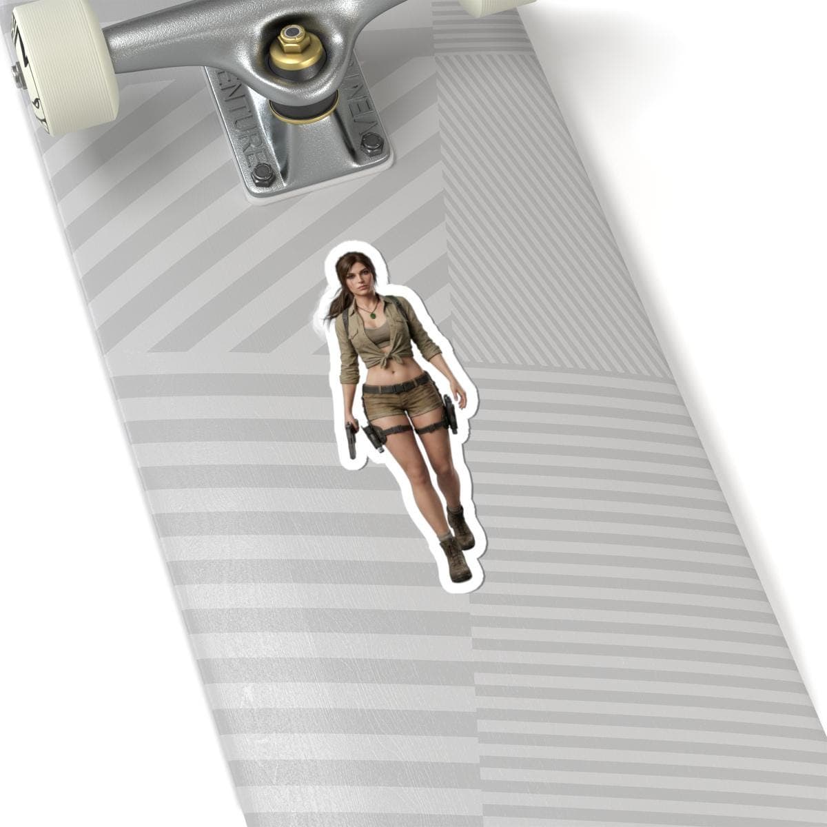 May include: A sticker featuring a woman in a khaki outfit, holding two pistols. She is wearing a short-sleeved shirt, shorts, and boots. The sticker is placed on a skateboard.