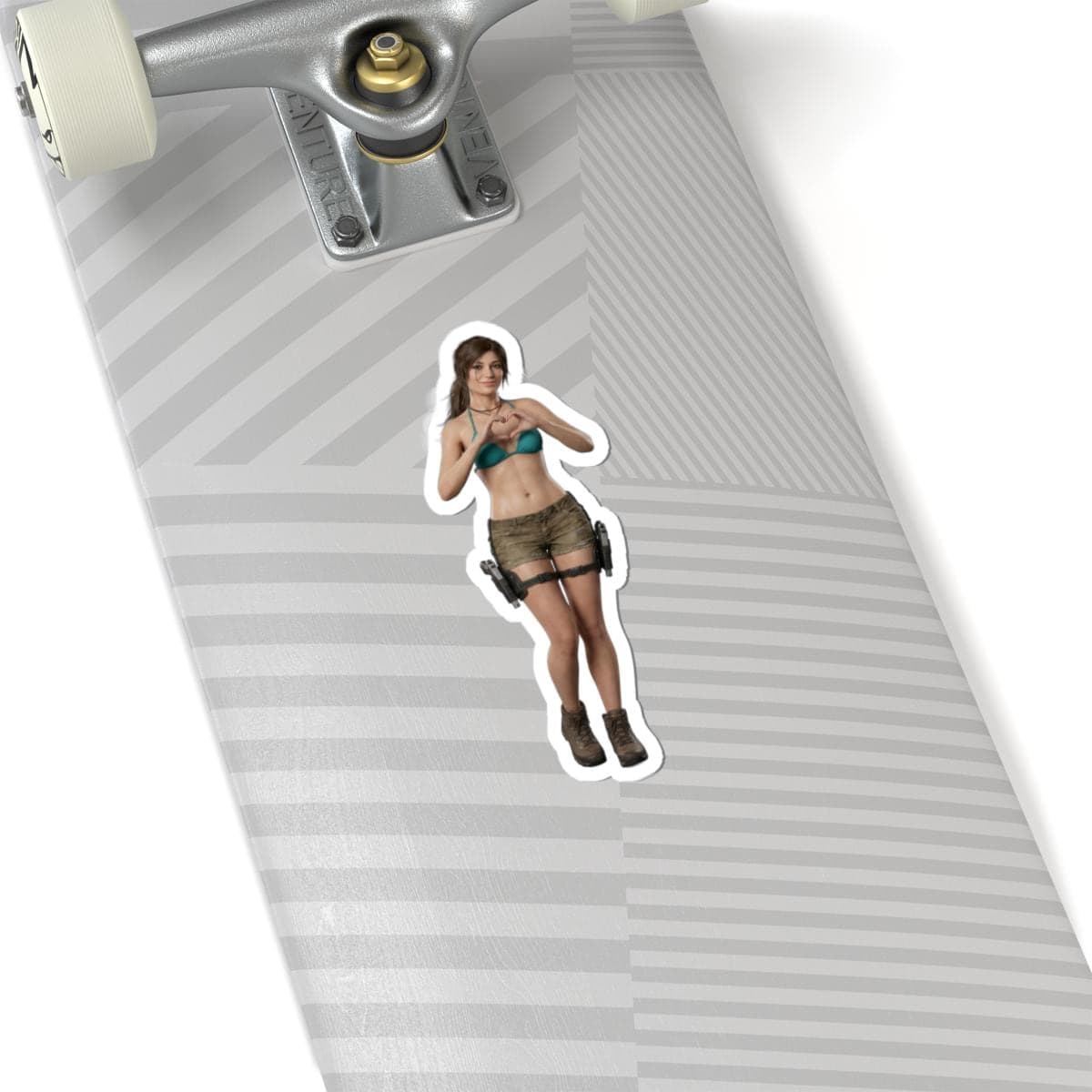 May include: A sticker featuring a woman in a teal bikini top and khaki shorts, making a heart shape with her hands. The sticker is on a skateboard with a gray and white striped pattern.