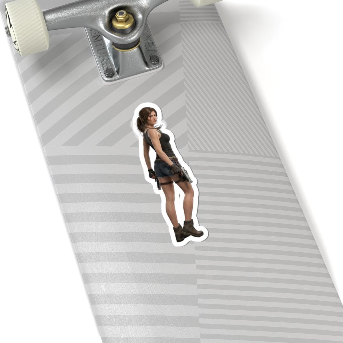 May include: A sticker featuring a female character in a black tank top, denim skirt, and boots. She is posed with a gun holster and gloves. The sticker is placed on a skateboard.