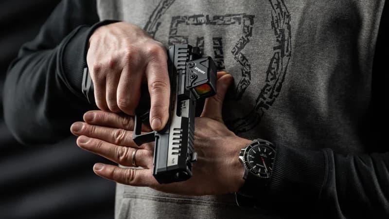 CZ P-10 C Ported COA held in hand showing Aimpoint COA lens and slide markings