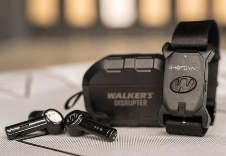 Walker's ShotSync wrist-worn shot timer displayed with accessories on a tabletop