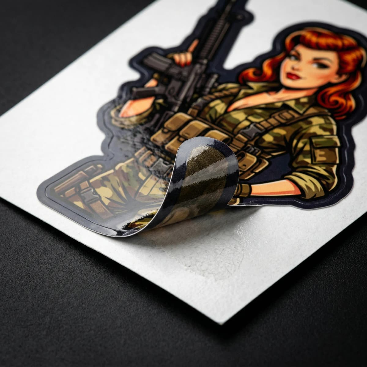 Close-up of die-cut vinyl sticker material showing quality and laminate finish