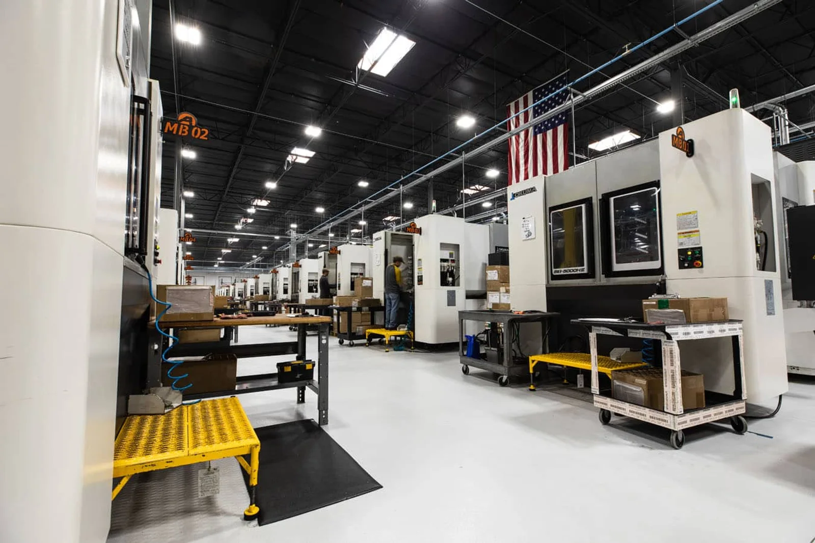 Rows of CNC machining centers inside an Aero Precision manufacturing facility