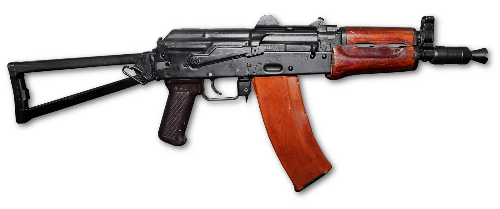 AKS-74U short-barreled carbine with side-folding metal stock extended, wood handguards, orange bakelite magazine, and expansion-chamber muzzle booster