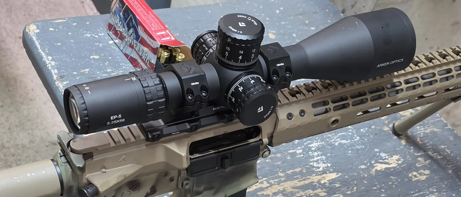 Close view of the Arken EP-5 5-25x56 turrets: the elevation cap marked ZERO STOP and 0.1 MRAD with two rows of numbers, the windage turret marked 0.1 MRAD, and the EP-5 5-25X56 marking on the eyepiece