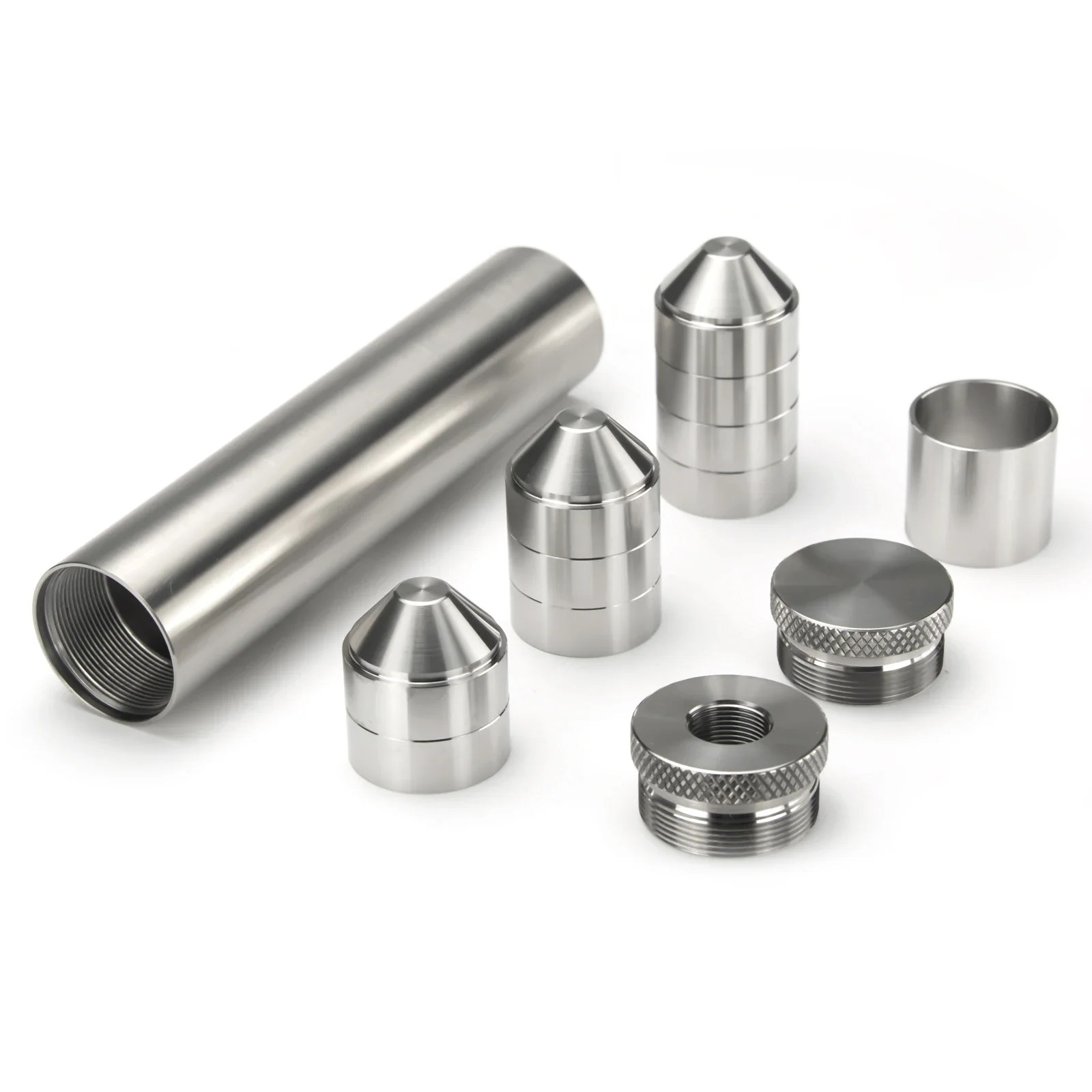 A stainless steel solvent trap kit laid out: an outer tube, stacked conical cups with no bore hole, a spacer, a knurled thread adapter, and an end cap