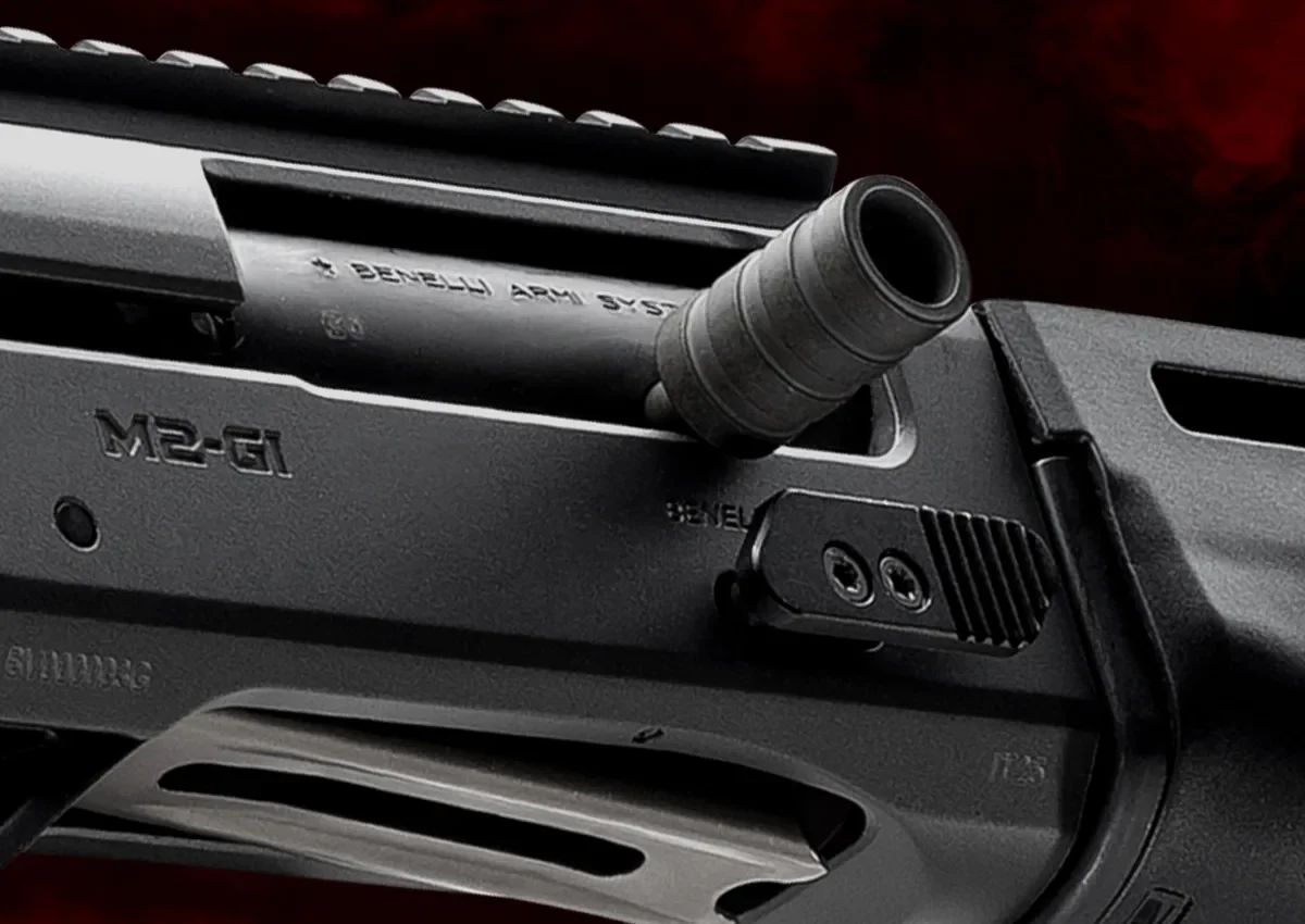 Close-up of the M2-G1 receiver showing the M2-G1 rollmark, oversized charging handle, and enlarged bolt release button