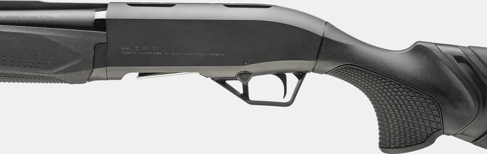 Left side of the Beretta A400 Solo receiver engraved A400 SOLO with the trigger group, checkered pistol grip and forend visible