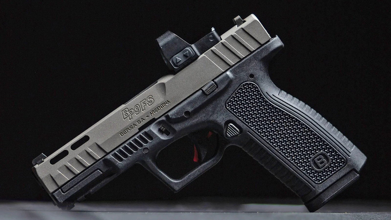 Bersa BP9 FS in two-tone finish with red dot optic mounted, showing the RMSc slide cut and grip texture