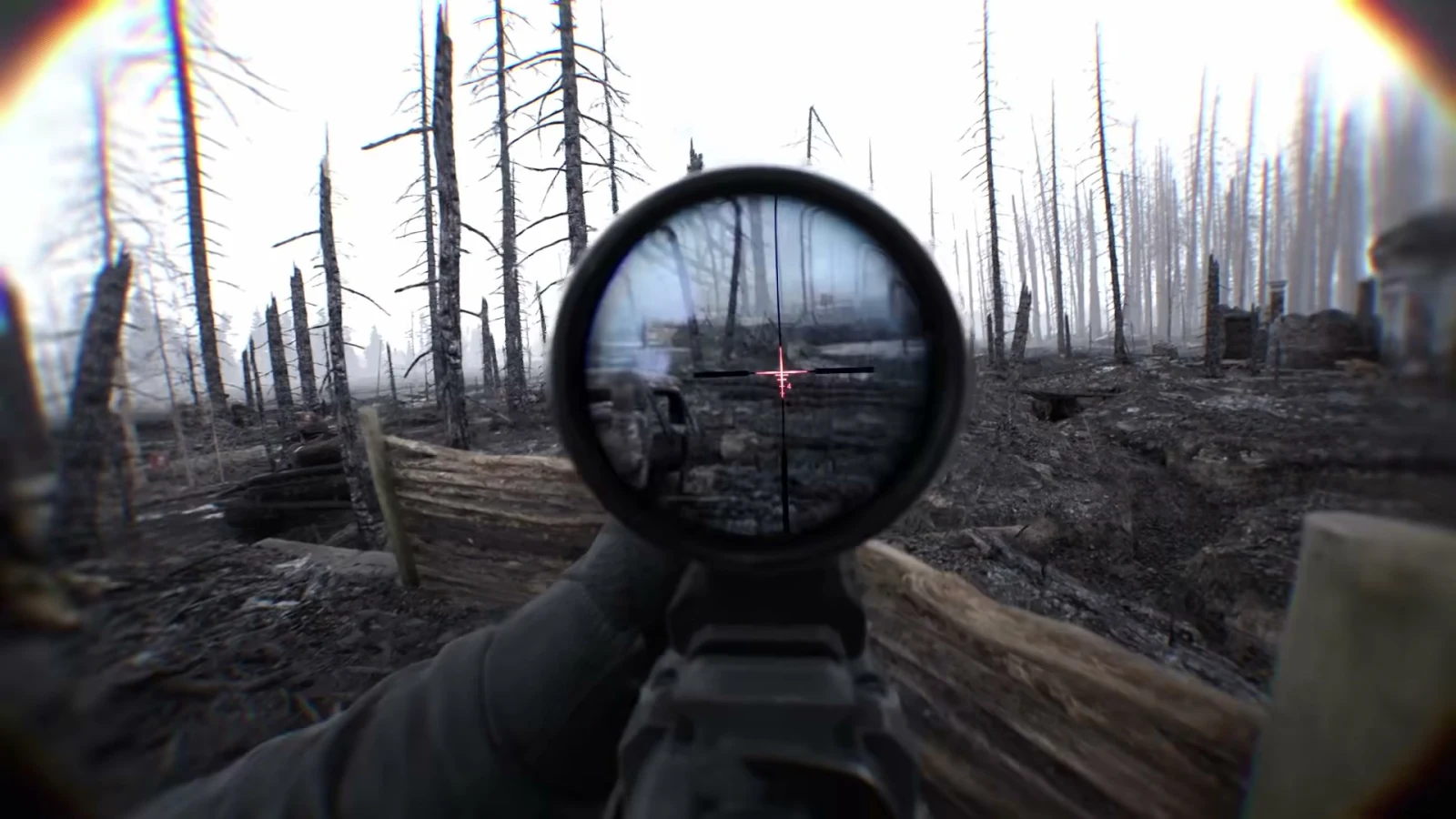 Bodycam gameplay viewed through a rifle optic from a timber-lined trench in a burned forest