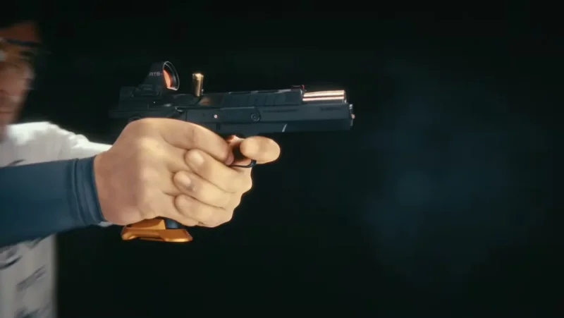 Slow-motion side view of the CZ TS 3 Orange slide cycling during firing, showing the Nitride-finished slide and smoke