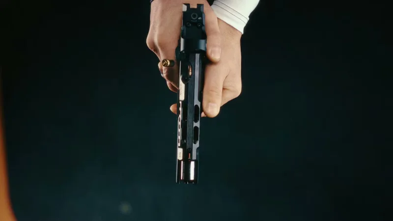 Top-down view of the CZ TS 3 Orange showing the slide-mounted optic and ejection port during firing