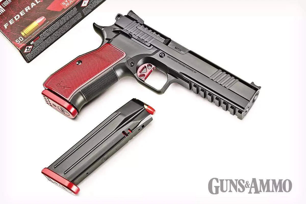 Dan Wesson DWX pistol laid out with a double-stack CZ-pattern magazine and loose 9mm cartridges