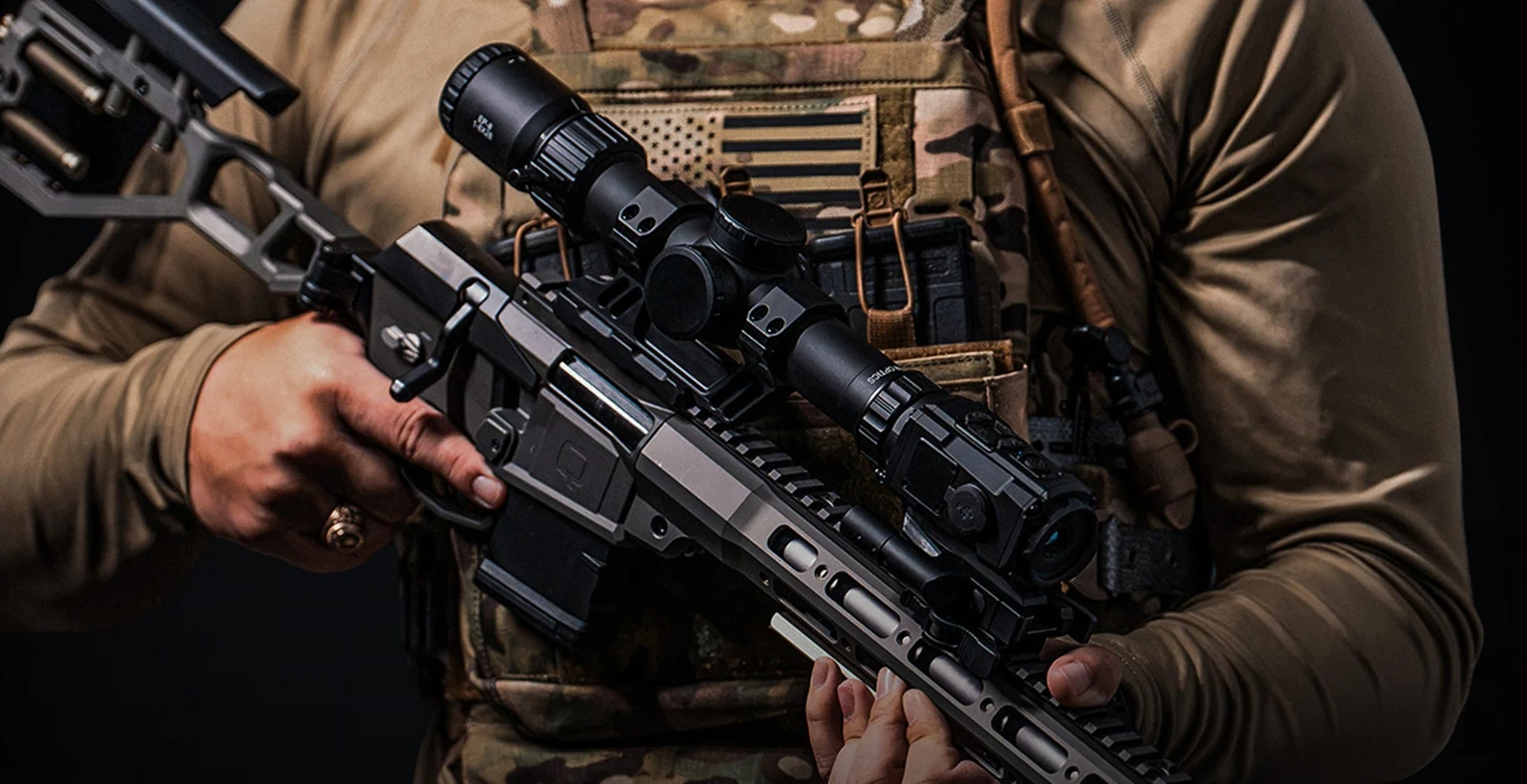 DNT HYDRA-Mini HS210M mounted on a rifle handguard rail directly in front of a low-power variable optic in clip-on configuration