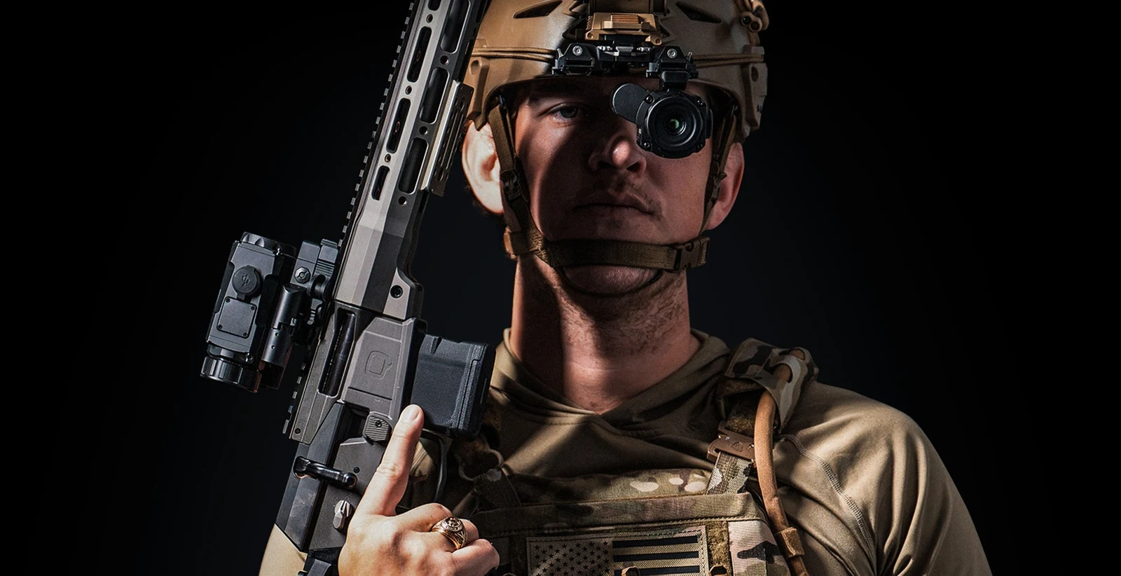 Shooter in a plate carrier and FAST helmet with a DNT HYDRA-Mini HS210M mounted to a rifle rail and a second unit mounted to the helmet