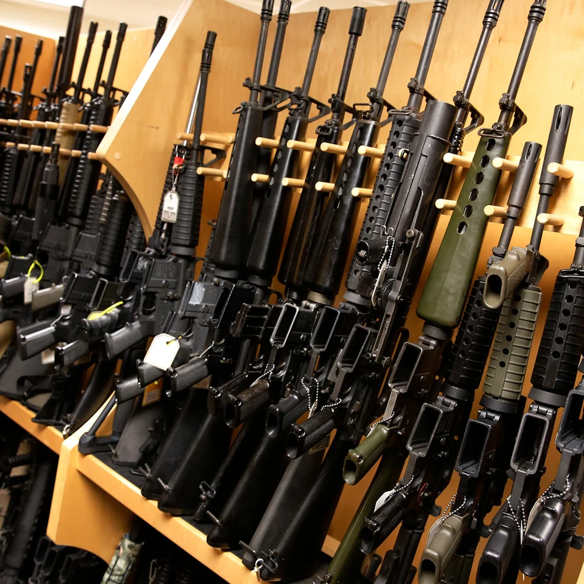 A rack of AR-15-style rifles displayed for sale in a gun shop.