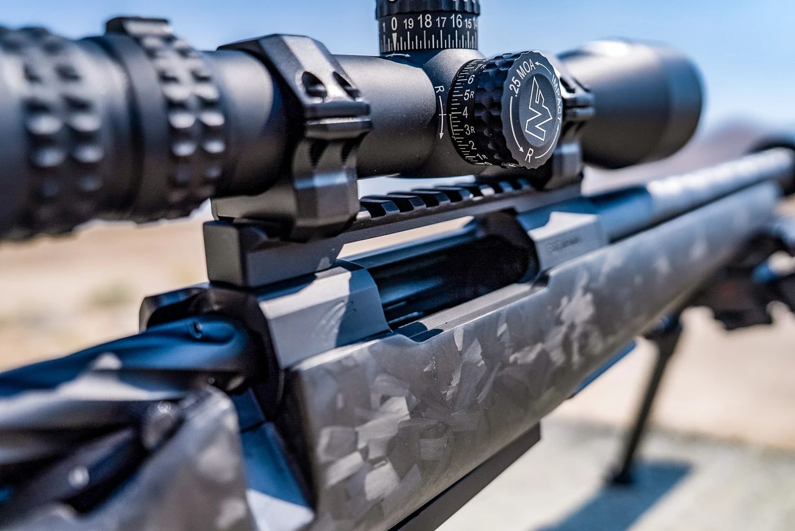Close view of the Fierce Wingman SBR receiver showing the Picatinny scope rail, Nightforce scope in rings, bolt handle, and chopped carbon stock