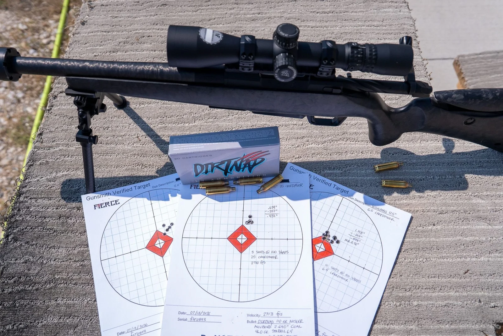 Fierce Wingman SBR with suppressor and bipod on a concrete bench beside a DirtNap ammunition box and three gunsmith-verified accuracy targets