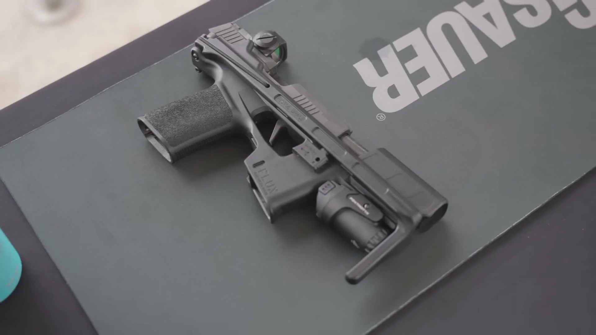 Flux Raider 365 on SIG Sauer display showing black polymer chassis with optic and light