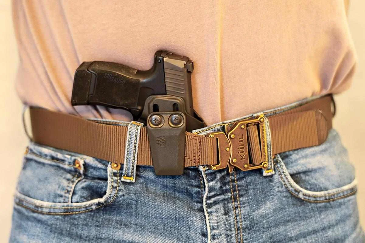 FN 309 MRD concealed carry setup with holster, spare magazine, and defensive ammunition