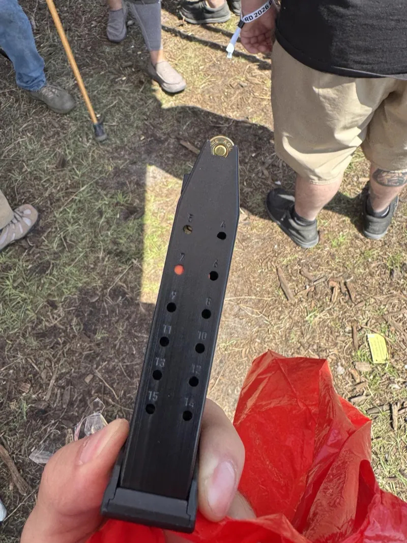 Glock factory 15-round Slimline magazine showing round count witness holes numbered 1 through 15