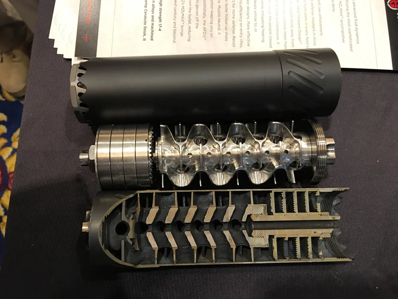 Flow-through suppressor diagram showing gas venting forward to reduce back-pressure