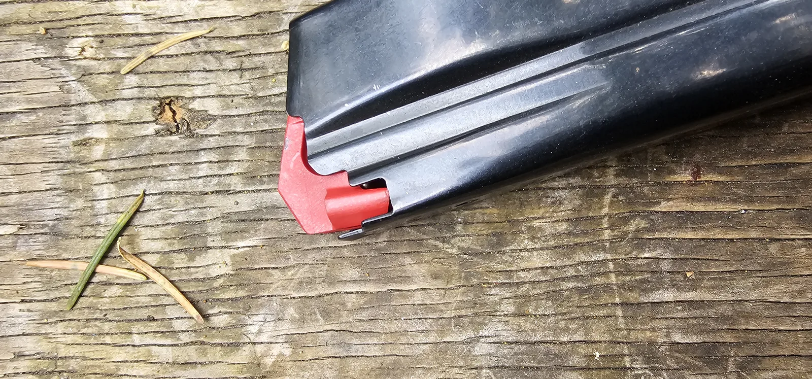 HK CC9 magazine with the red polymer follower knocked out of position at the feed lips