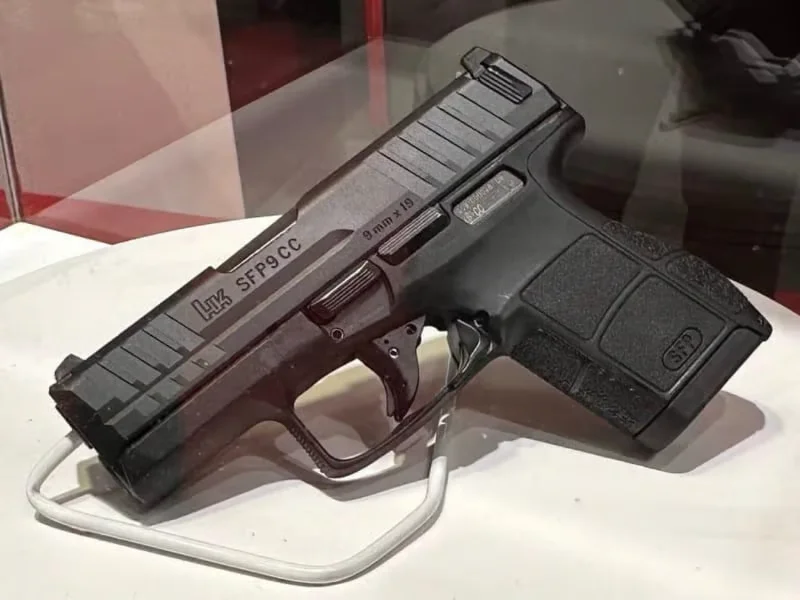 The Heckler and Koch SFP9CC micro-compact 9mm pistol on a display stand, showing the slide markings and compact frame