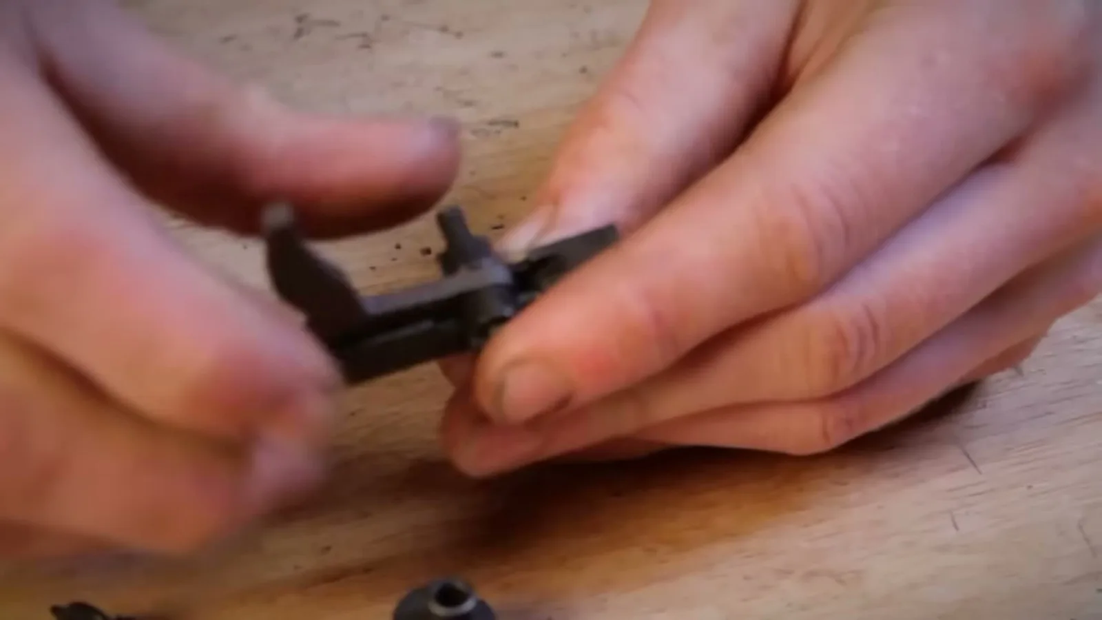 Close-up of the Trigger Kicker being seated into an AR-15 trigger body with the fire control pin
