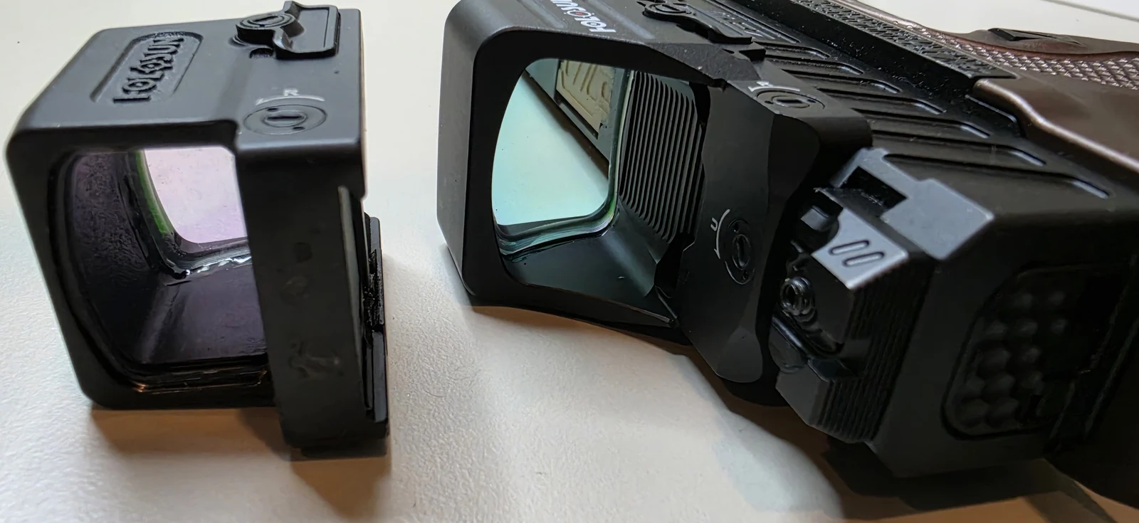 The Holosun 507COMP mounted on the ZEV pistol next to a Holosun 509T on the bench