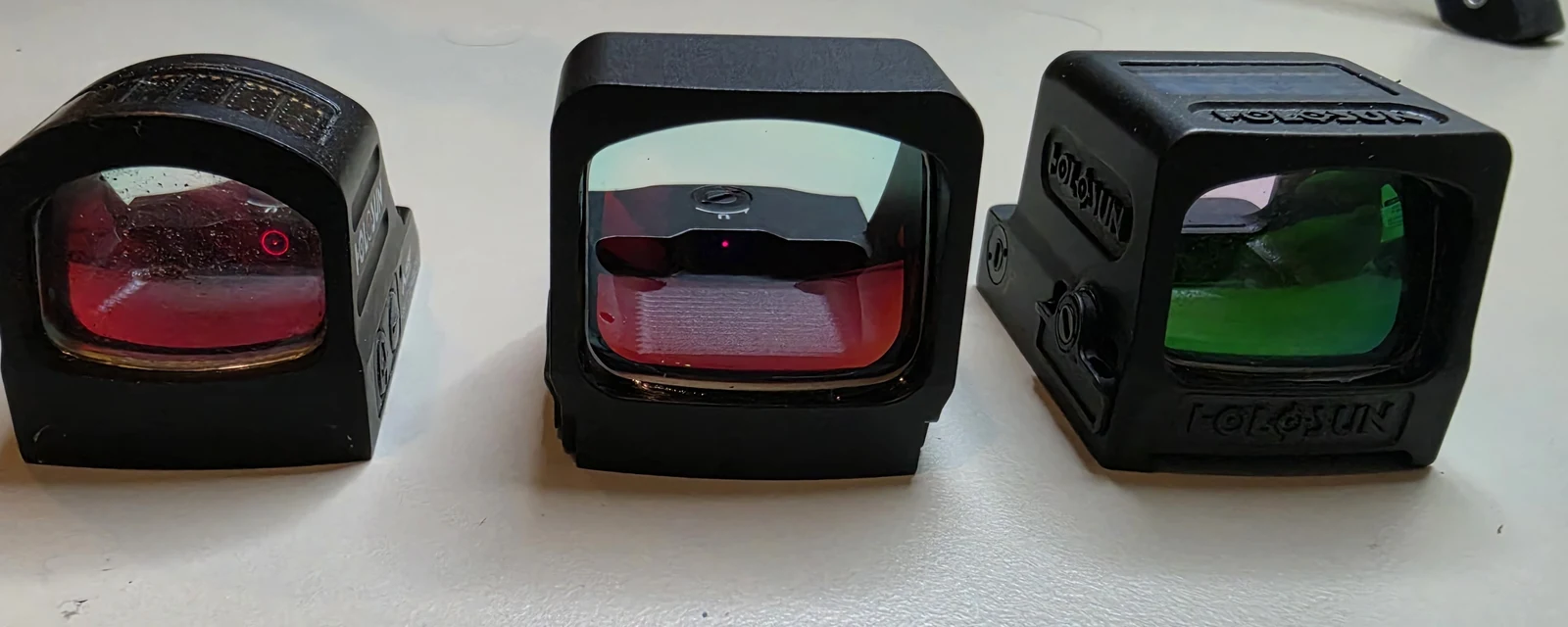 Holosun 507C, 507COMP, and 509T lined up front-on showing the difference in window size