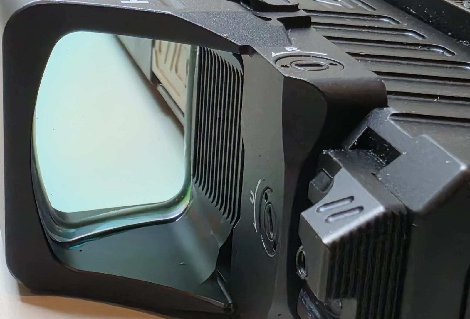 Close-up of the Holosun 507COMP window showing the wide viewing area and the side battery tray