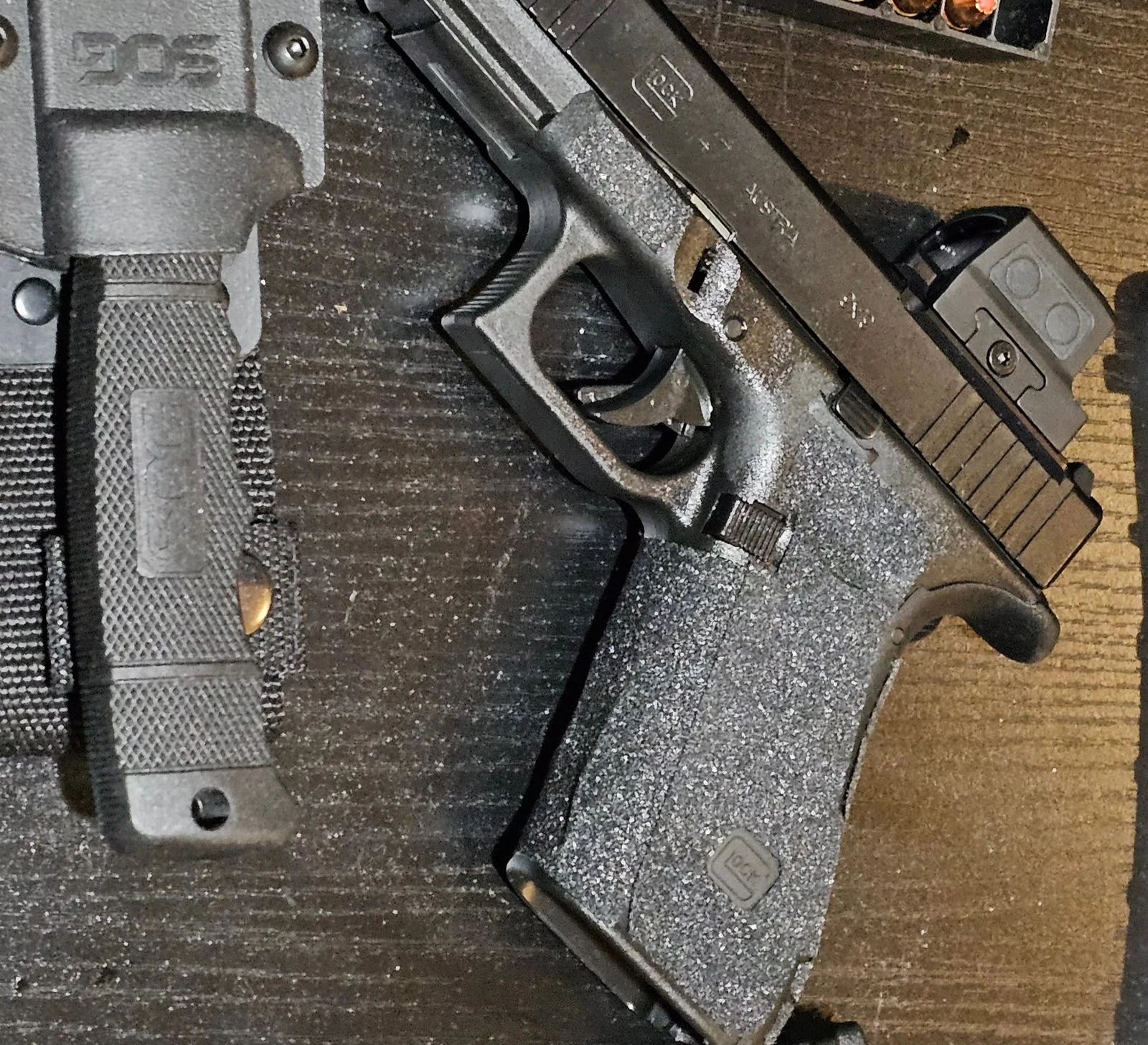 Glock 47 MOS with Holosun 509T X2 Gold mounted, staged with 9mm ammunition and a fixed-blade knife