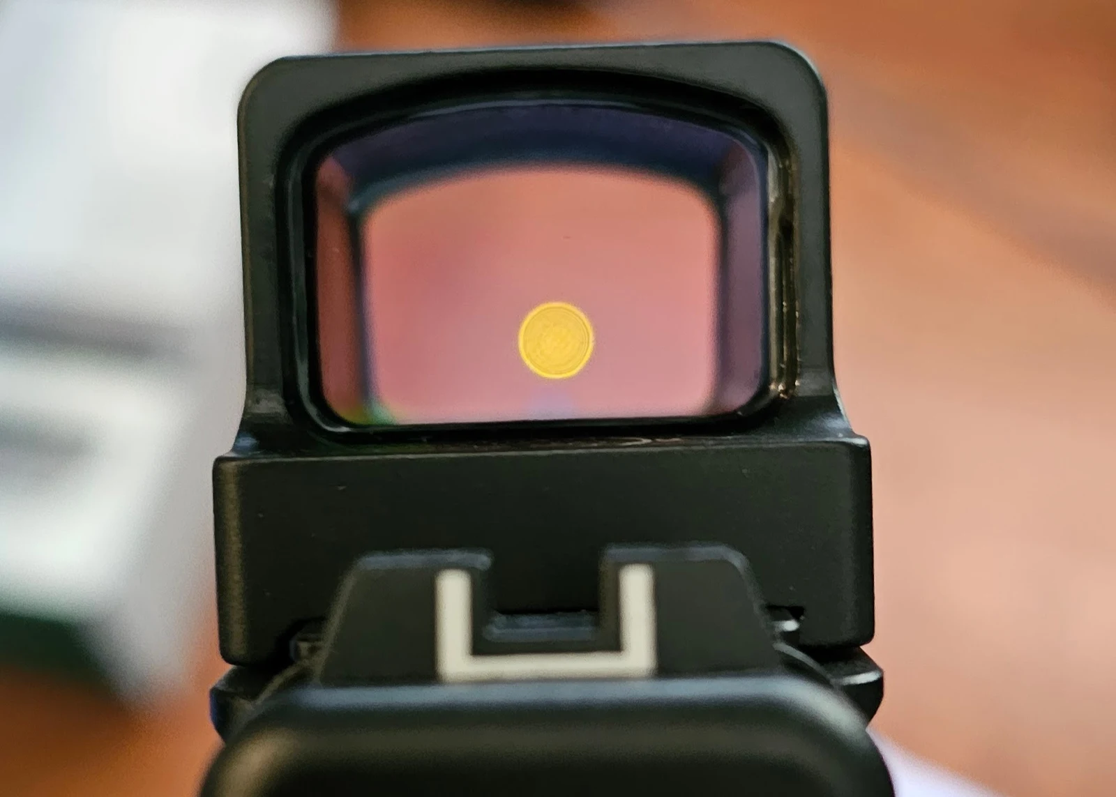 Gold 2 MOA dot visible through the Holosun 509T X2 Gold window with a suppressor-height rear iron sight below