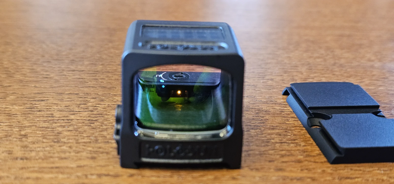 Holosun 509T X2 Gold titanium housing next to the included RMR-to-509T adapter plate