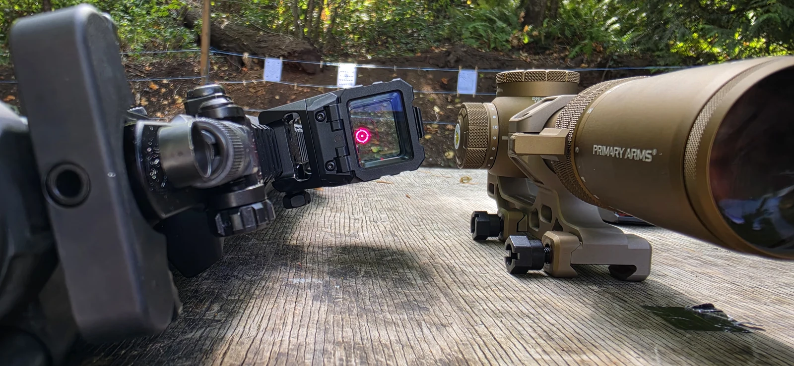 Holosun AEMS Pro X2 mounted on a rifle at a range bench with the circle-dot reticle lit