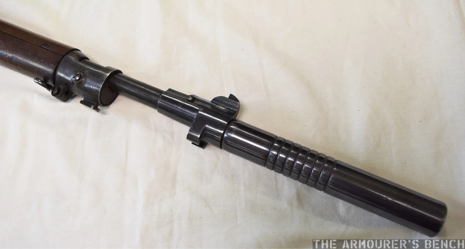 Original Hiram Percy Maxim Model 1910 silencer mounted on a Springfield rifle barrel showing the offset-bore design