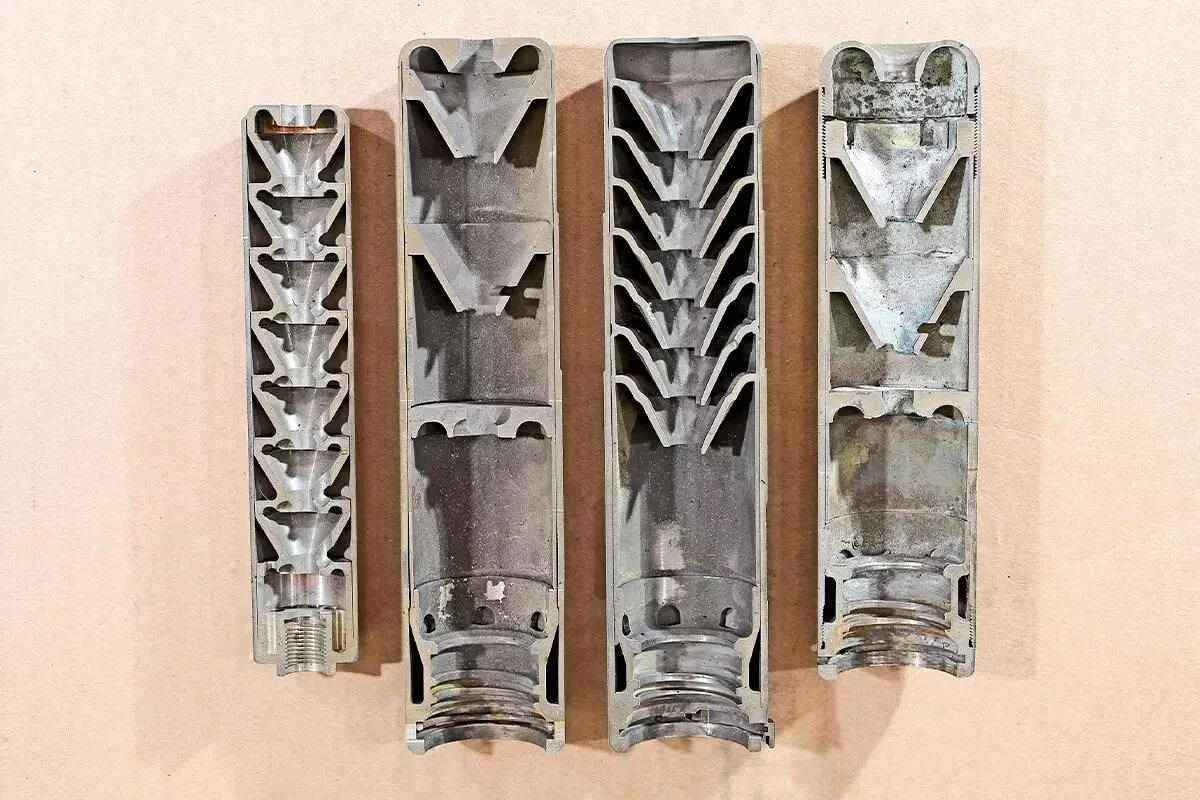 Cutaway comparison of suppressor baffle stack designs including monocore and K-baffle configurations