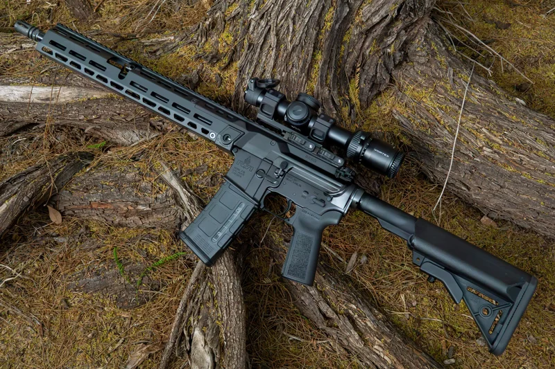 IWI ARAD 5 piston-driven rifle with a Vortex optic resting on a tree log in a wooded environment