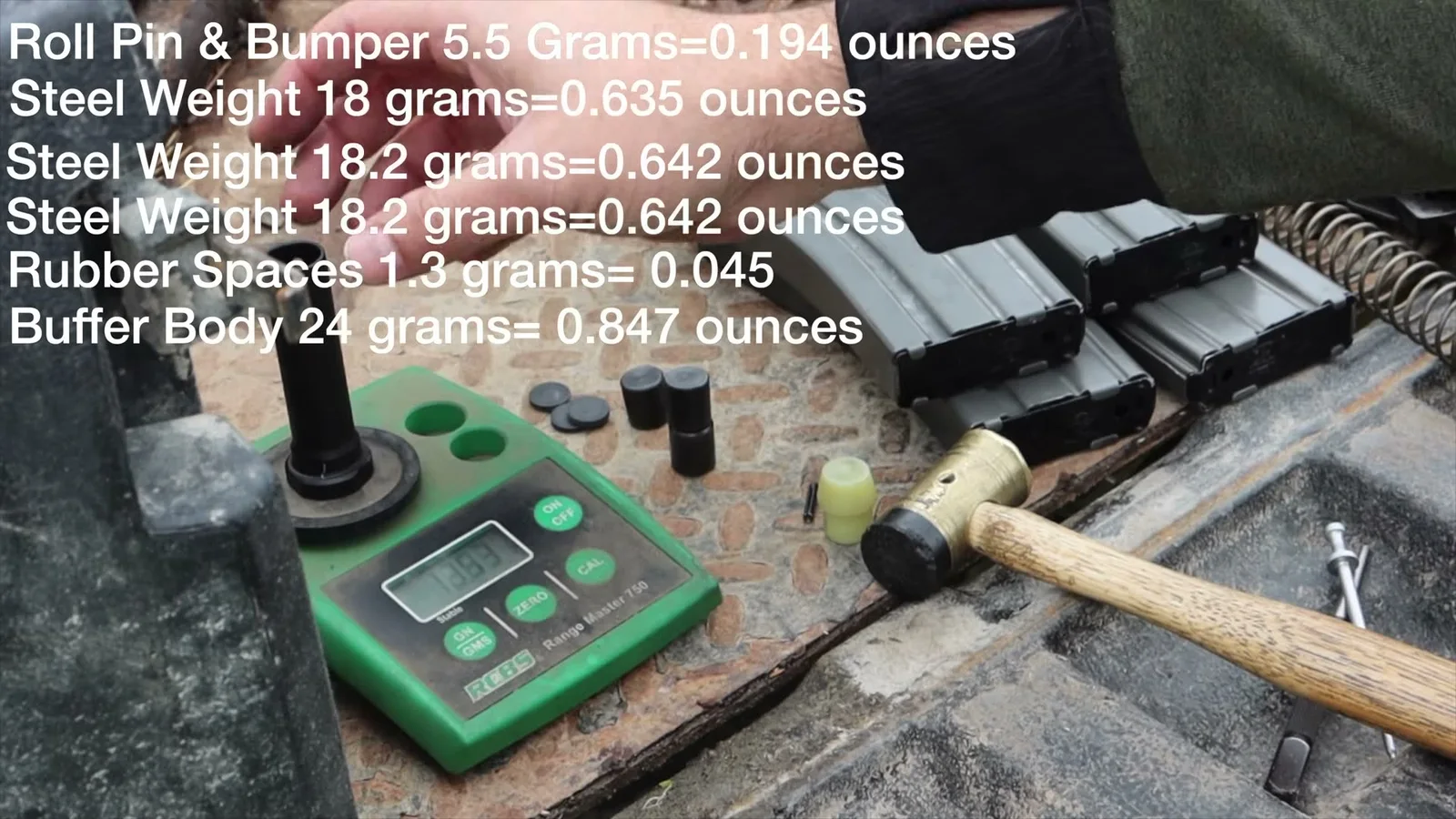 KAK weighing the internal parts of a standard AR-15 carbine buffer on a scale, with on-screen labels for the steel weights and buffer body
