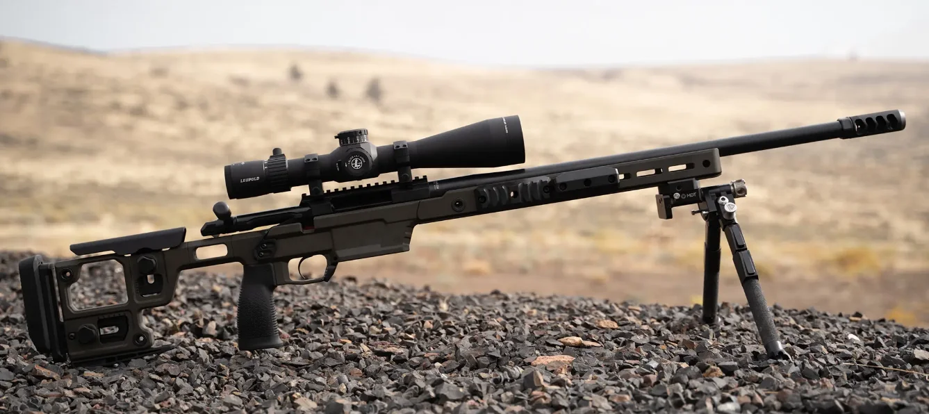 Leupold Mark 4HD 8-32x56 riflescope mounted on a precision bolt-action rifle in a shooting position