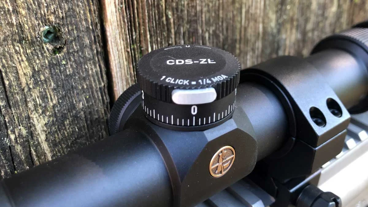 Detail view of a Leupold ZeroLock elevation turret showing the locking mechanism and revolution markings