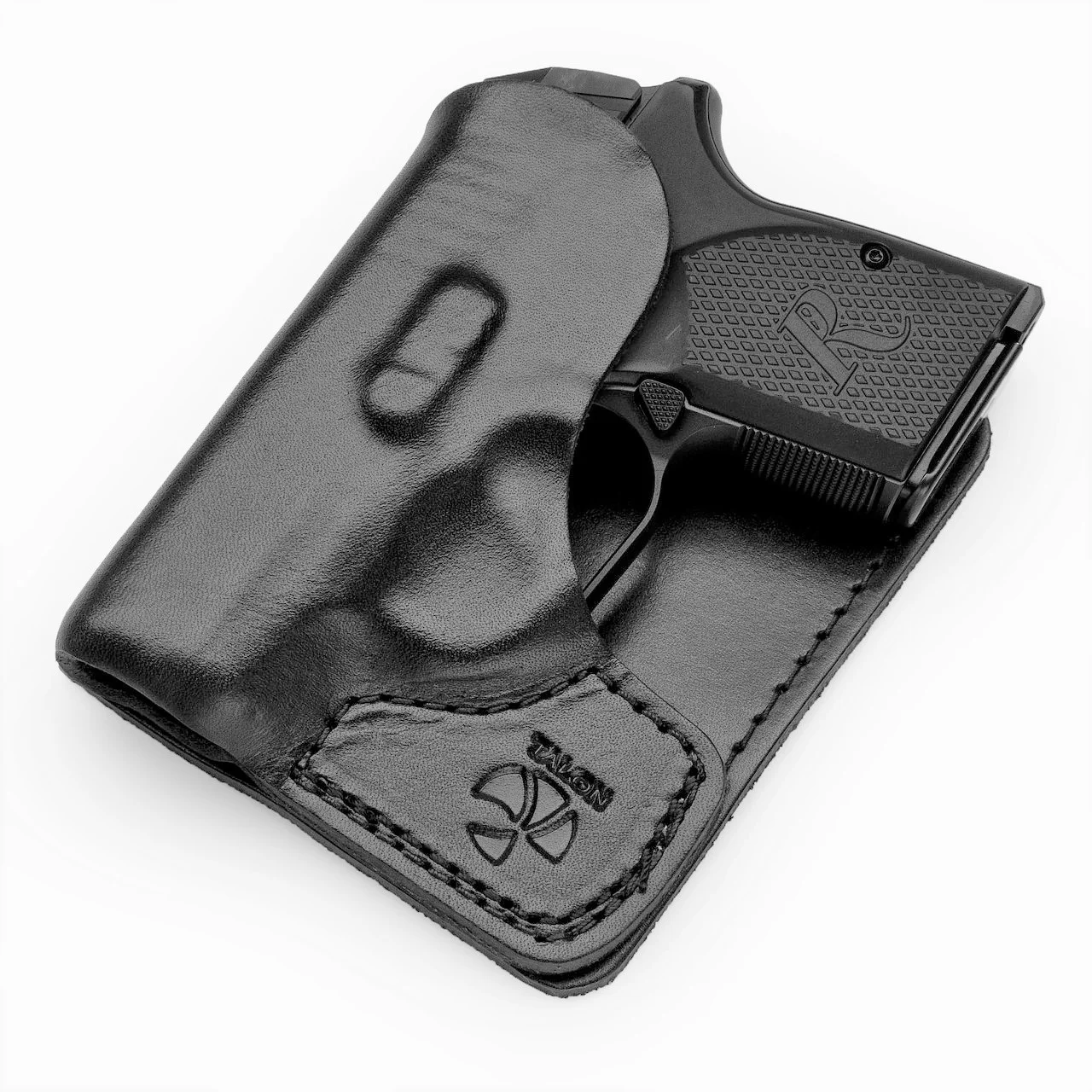 Compact pocket .380 ACP pistol with concealed-carry holster on wooden surface